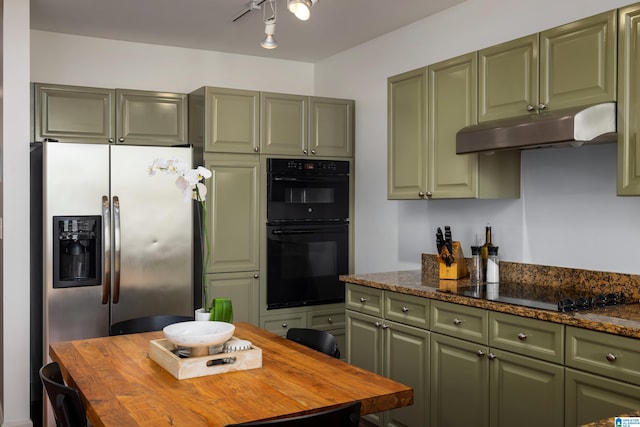 kitchen featuring green cabinets, black appliances, and butcher block counters