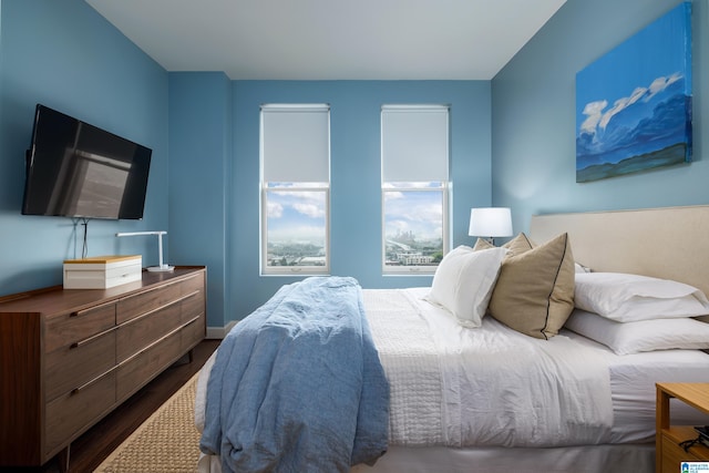 bedroom with dark hardwood / wood-style flooring