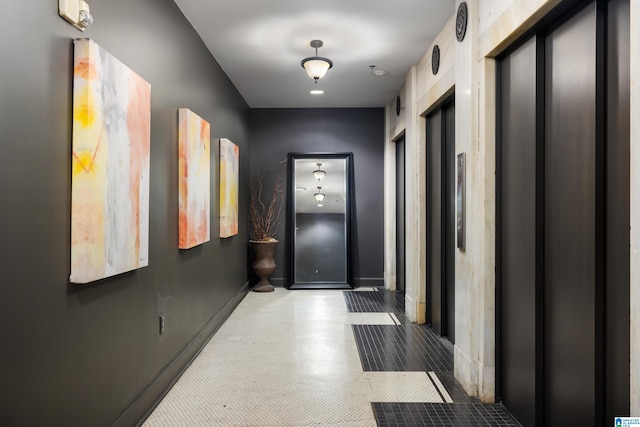 hall with elevator and tile patterned flooring