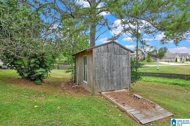 view of shed featuring fence