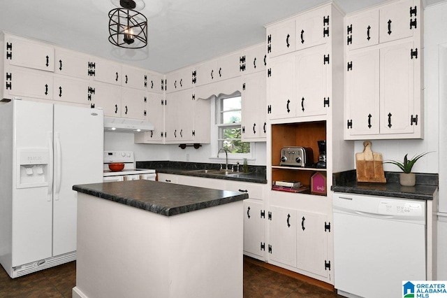 kitchen with under cabinet range hood, white appliances, a sink, dark countertops, and white cabinets