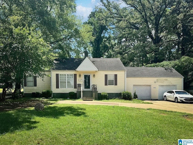 view of front of home with a front lawn and a garage