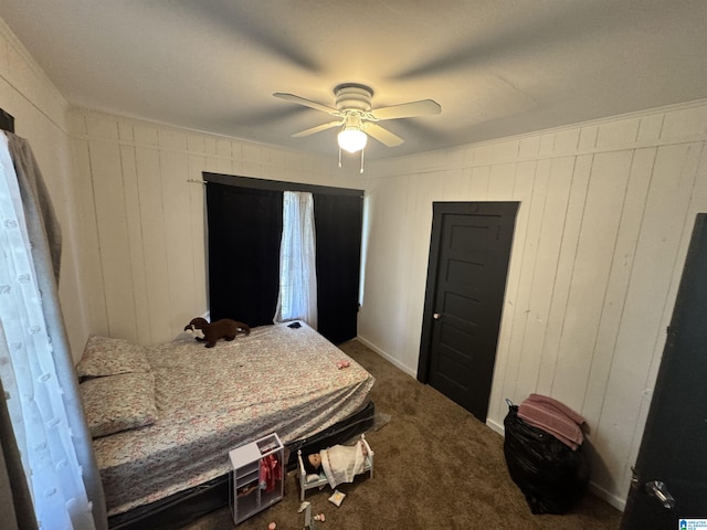 bedroom featuring ceiling fan and dark carpet