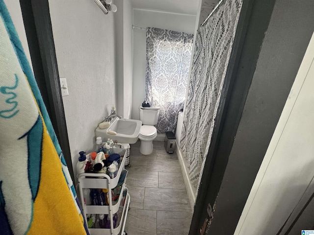 bathroom with sink, tile patterned floors, and toilet