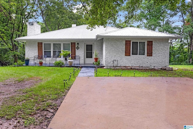 408 N Main St, Graysville, AL 35073 - ranch-style house with a chimney, stucco siding, a front yard, a porch, and metal roof