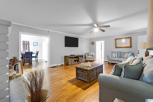 408 N Main St, Graysville, AL 35073 - living area with crown molding, light wood finished floors, ceiling fan, and baseboards