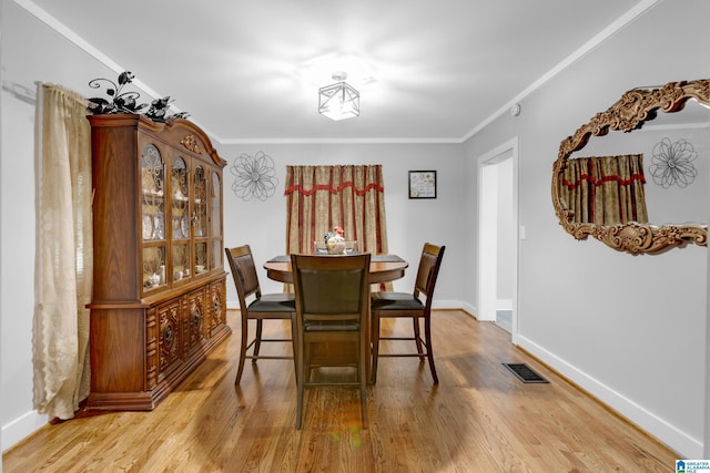 408 N Main St, Graysville, AL 35073 - dining area with wood finished floors, baseboards, and ornamental molding