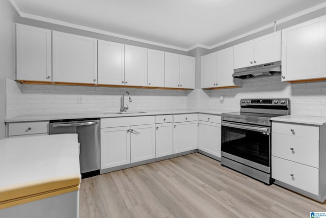 408 N Main St, Graysville, AL 35073 - kitchen with appliances with stainless steel finishes, under cabinet range hood, a sink, light countertops, and light wood finished floors