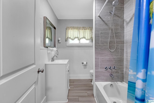 408 N Main St, Graysville, AL 35073 - bathroom featuring toilet, bathtub / shower combination, vanity, wainscoting, and wood finished floors