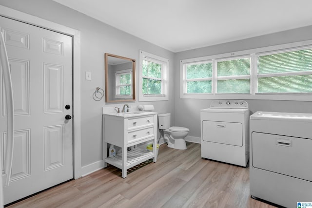 408 N Main St, Graysville, AL 35073 - laundry room featuring separate washer and dryer, light wood-style flooring, and baseboards