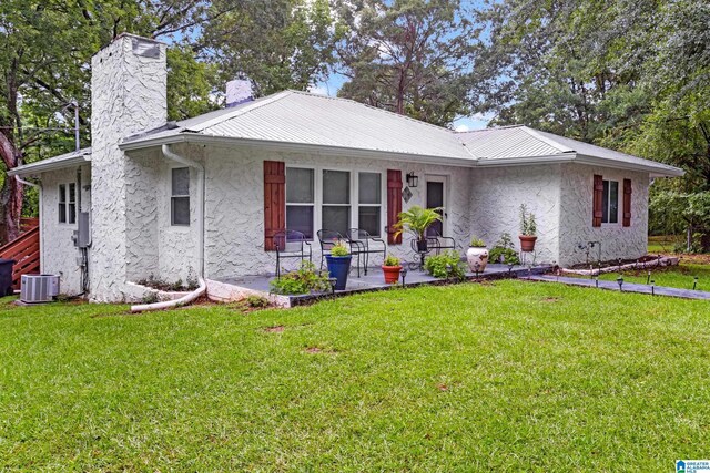 408 N Main St, Graysville, AL 35073 - single story home with stucco siding, a chimney, a patio, and a front yard