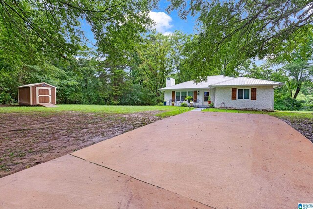 408 N Main St, Graysville, AL 35073 - single story home featuring a storage unit, a chimney, an outdoor structure, covered porch, and concrete driveway
