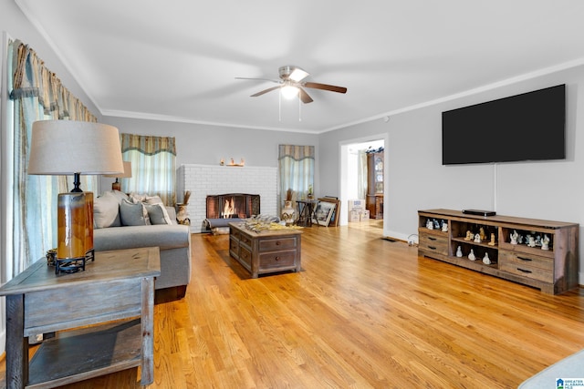 408 N Main St, Graysville, AL 35073 - living area with ceiling fan, plenty of natural light, light wood-style flooring, a brick fireplace, and ornamental molding