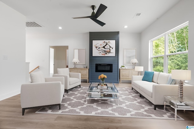 living room with ceiling fan and hardwood / wood-style flooring