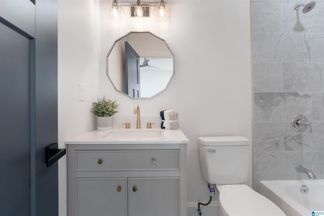 full bathroom featuring toilet, vanity, and tiled shower / bath