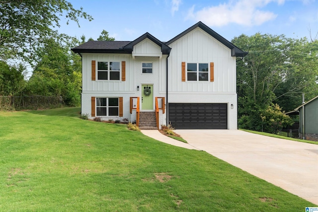 raised ranch with a front yard and a garage