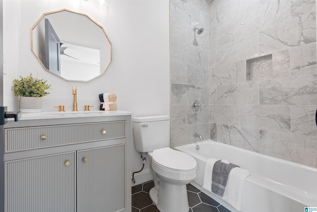 full bathroom with vanity, tile patterned floors, tiled shower / bath combo, and toilet