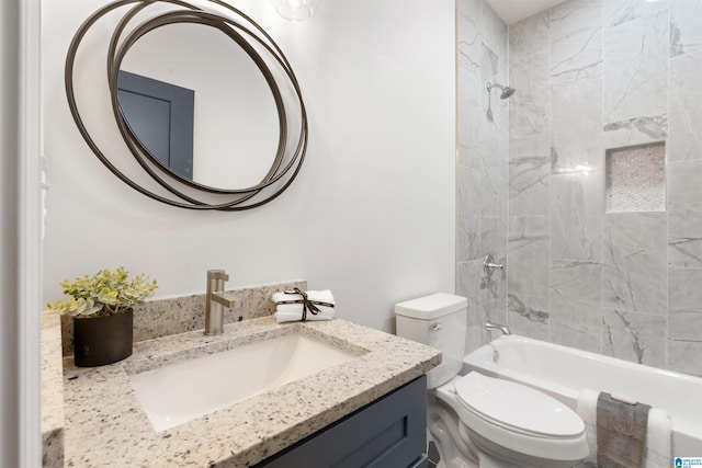 full bathroom with toilet, vanity, and tiled shower / bath