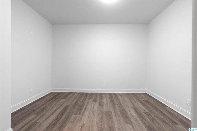 spare room with dark hardwood / wood-style flooring