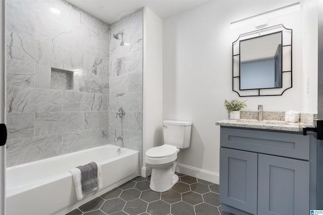 full bathroom featuring vanity, tile patterned floors, tiled shower / bath combo, and toilet