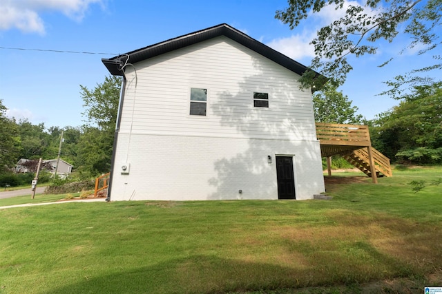 view of home's exterior featuring a yard and a deck