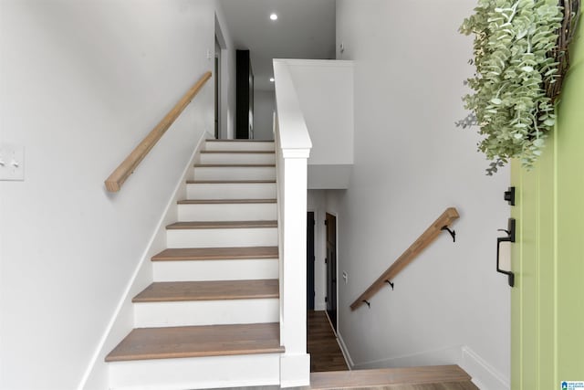 stairs featuring hardwood / wood-style flooring