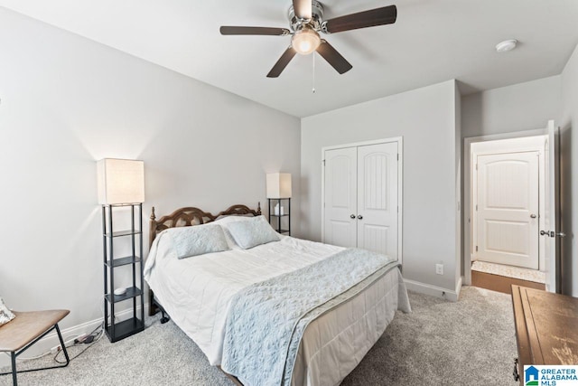 carpeted bedroom with ceiling fan and a closet