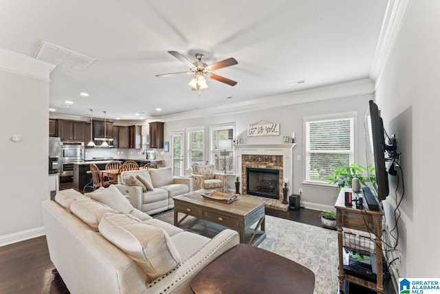 living room with dark hardwood / wood-style floors, ceiling fan, and crown molding