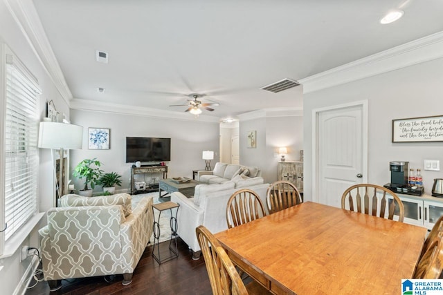 dining room with dark hardwood / wood-style flooring, ceiling fan, and crown molding