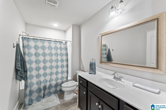 bathroom with tile patterned floors, vanity, and toilet