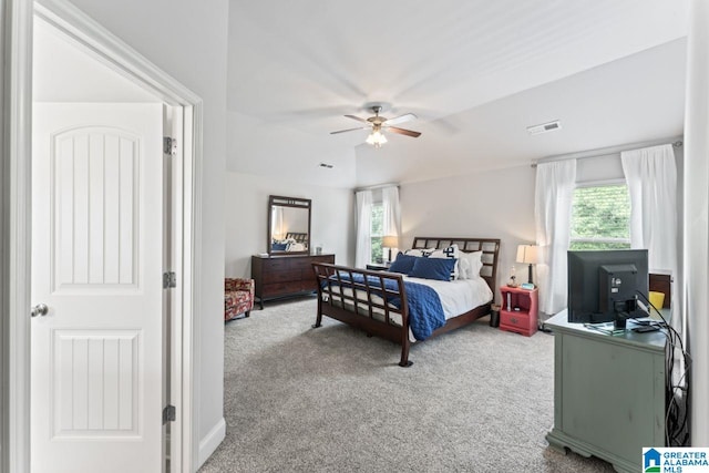 carpeted bedroom with ceiling fan and multiple windows