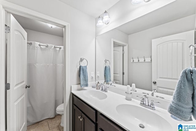 bathroom featuring tile patterned floors, vanity, and toilet