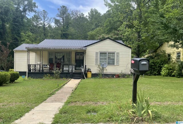 view of front of property with covered porch and a front lawn