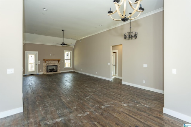 unfurnished living room with ornamental molding, dark wood-style flooring, baseboards, and ceiling fan with notable chandelier