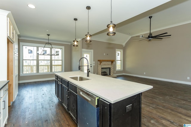 kitchen with dark wood finished floors, ornamental molding, a brick fireplace, a sink, and dishwasher