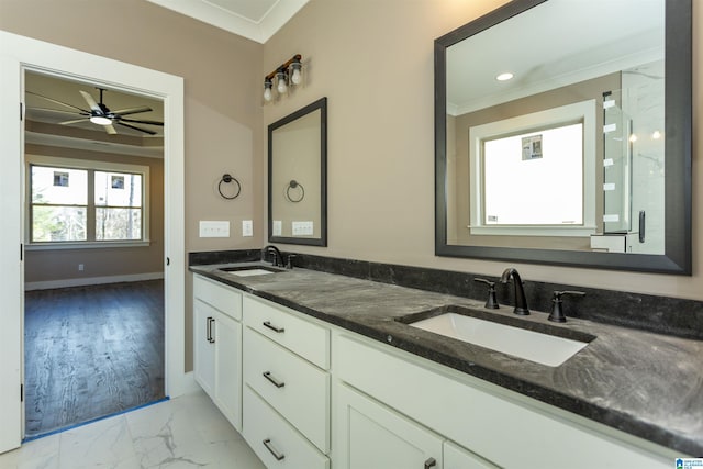 bathroom featuring marble finish floor, a sink, and crown molding