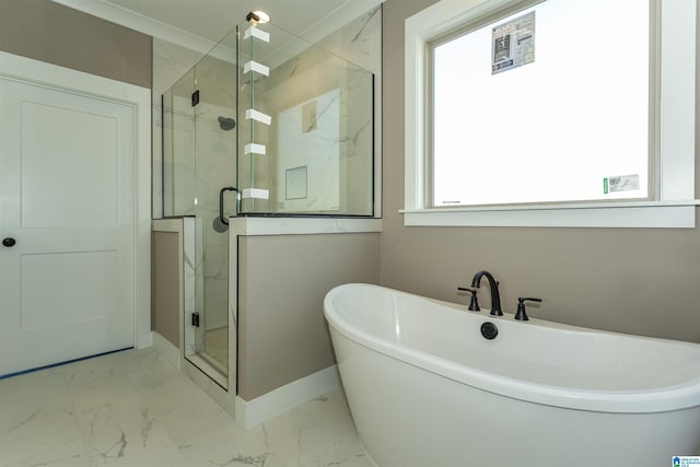 bathroom with marble finish floor, a marble finish shower, and a freestanding tub