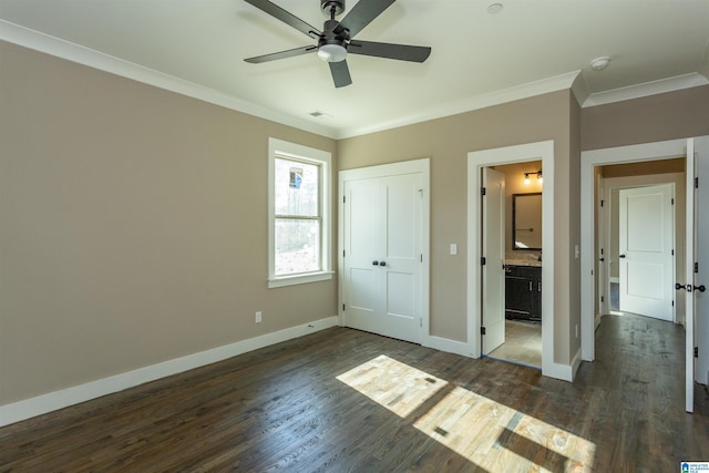 unfurnished bedroom with ornamental molding, dark wood-style flooring, visible vents, and baseboards