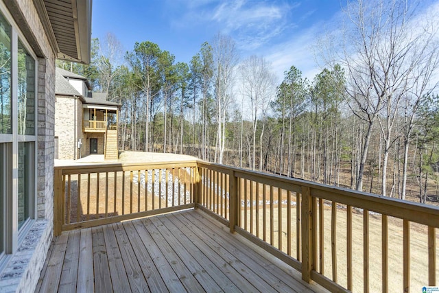 wooden deck featuring a wooded view