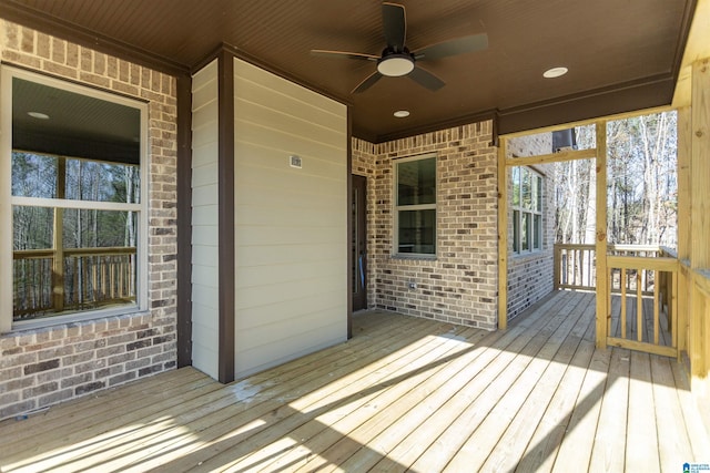 wooden deck featuring a ceiling fan