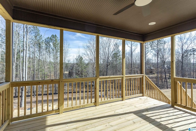 unfurnished sunroom featuring a ceiling fan