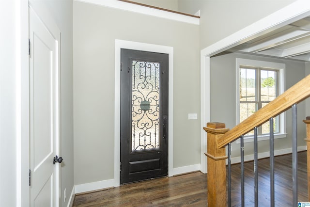 foyer with stairs, baseboards, and dark wood-type flooring