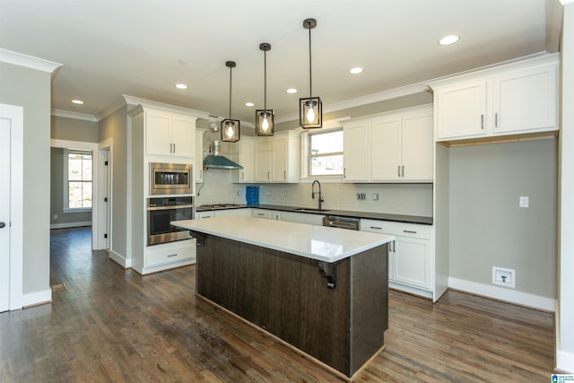 kitchen featuring tasteful backsplash, appliances with stainless steel finishes, crown molding, white cabinetry, and a sink