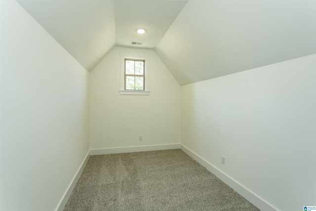 bonus room featuring carpet floors, visible vents, vaulted ceiling, and baseboards