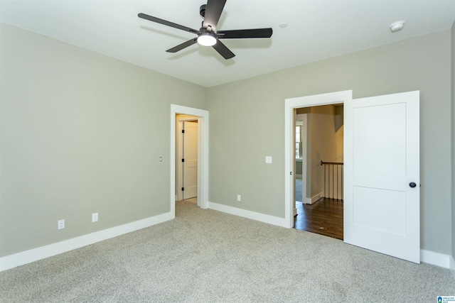 unfurnished bedroom featuring a ceiling fan, baseboards, and carpet flooring