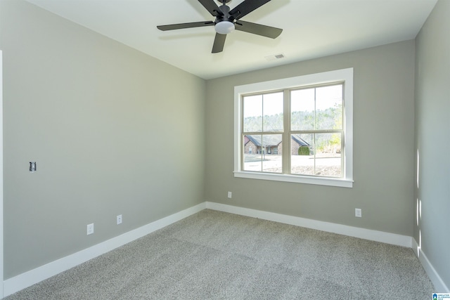 unfurnished room featuring carpet, baseboards, and visible vents