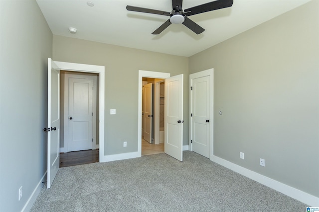 unfurnished bedroom featuring carpet, ceiling fan, and baseboards