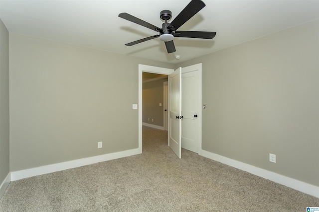 unfurnished bedroom featuring a ceiling fan, baseboards, and carpet flooring