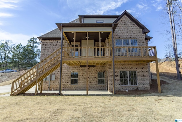 back of property featuring stairs and brick siding