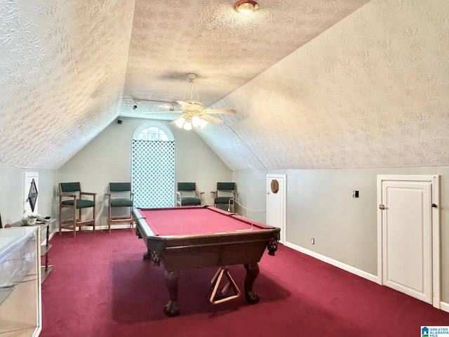 recreation room featuring ceiling fan, billiards, vaulted ceiling, a textured ceiling, and carpet